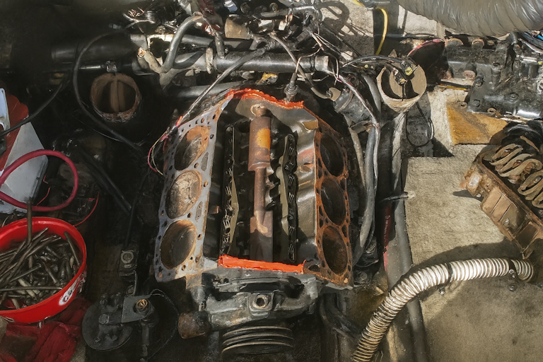 engine work image of a boat engine being stripped down