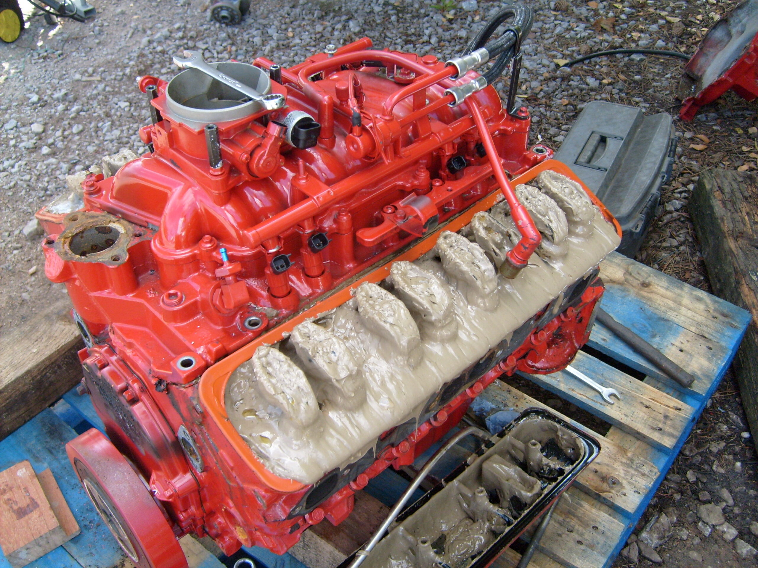 Home V8 marine engine during rebuild—emulsified oil ‘mayonnaise’ visible under rocker covers (before service).