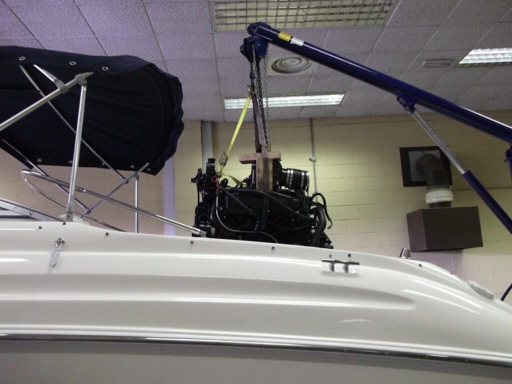 engine removal photo of an engine being craned out of a boat